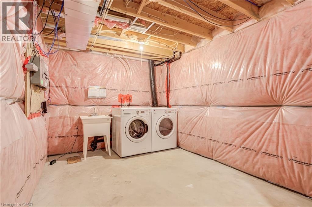 Laundry area featuring concrete floors and washer and clothes dryer - 239 Cranbrook Street, Kitchener, ON - Indoor Photo Showing Laundry Room