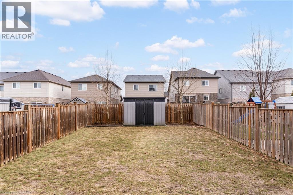 Fenced backyard featuring a residential view and a storage unit - 239 Cranbrook Street, Kitchener, ON - Outdoor