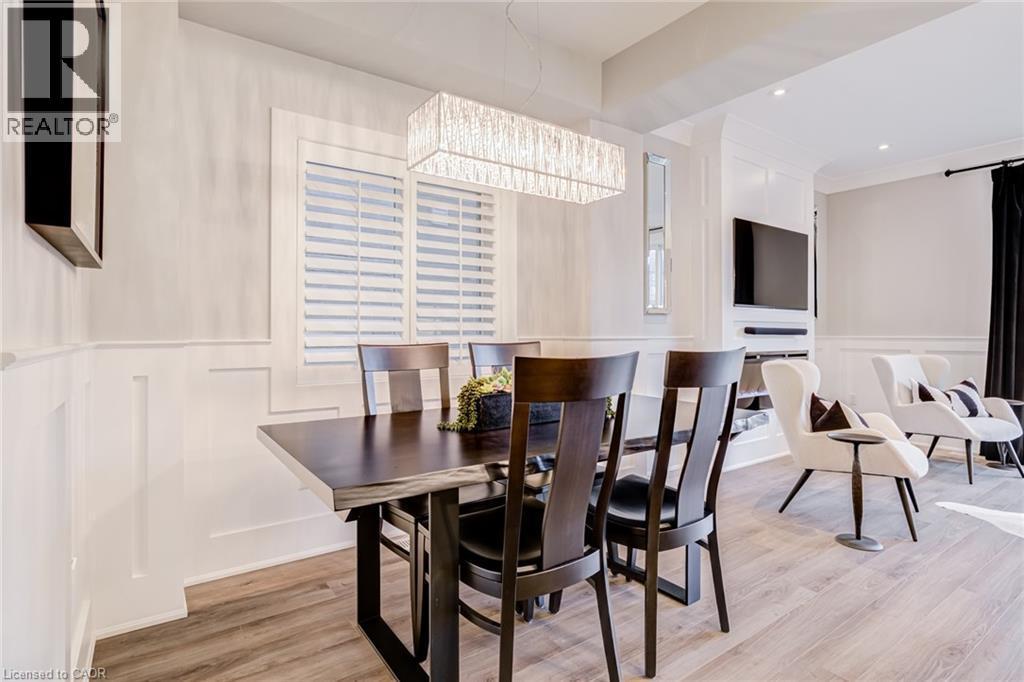 Dining room featuring a decorative wall, light wood finished floors, a wainscoted wall, and recessed lighting - 239 Cranbrook Street, Kitchener, ON - Indoor Photo Showing Dining Room