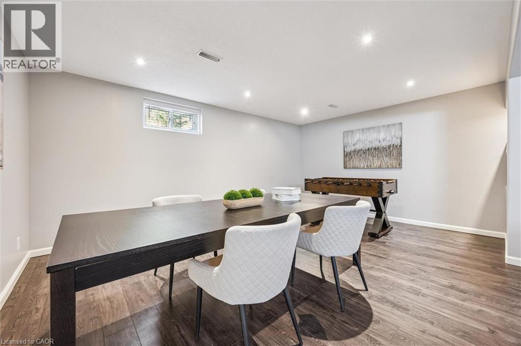 Spacious lower level living area featuring wood-finish flooring, recessed lighting, and light-toned walls - 828 Copper Ridge Drive, Waterloo, ON - Indoor