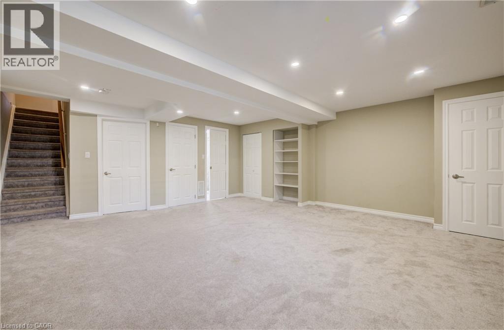 Spacious lower-level room featuring light gray carpeting and recessed lighting - 80 Miranda Path, Elmira, ON - Indoor Photo Showing Basement