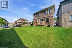 Expansive green lawn extending from the rear of the property - 
