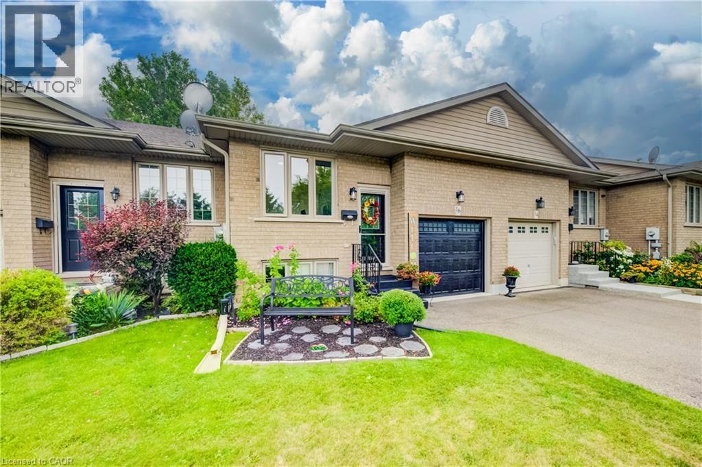 Brick exterior with gabled roofline, and paved driveway - 16 Steed Court, Brantford, ON