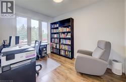 Room with wood-finish flooring, white walls, and built-in shelving - 