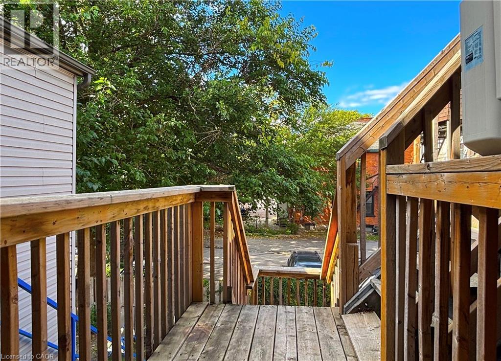 Outdoor wood deck with natural wood railing and balusters - 76 Wentworth Street S, Hamilton, ON