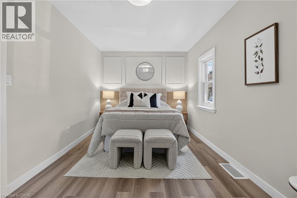 Wood-finish flooring, white trim, recessed ceiling light, and a single window - 43 E Brucedale Avenue E, Hamilton, ON