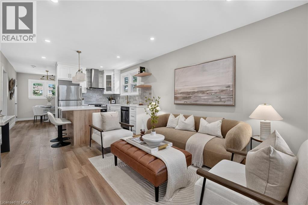Open-concept living space featuring wood-finish flooring, recessed lighting, and a kitchen island with seating - 43 E Brucedale Avenue E, Hamilton, ON