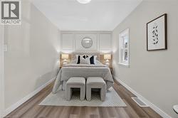 Wood-finish flooring, white trim, recessed ceiling light, and a single window -