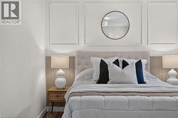 Upholstered tufted headboard against a wood-finish slatted accent wall -