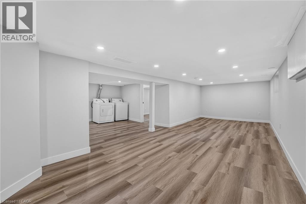 Spacious room featuring wood-finish flooring, recessed lighting, and light-toned wall finishes - 43 Brucedale Avenue E, Hamilton, ON
