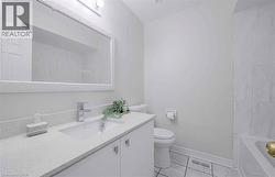 Integrated vanity with a white countertop and undermount sink, chrome faucet, framed mirror, and tiled flooring - 