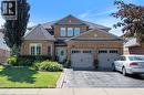 Brick exterior with multiple gables, a turret-style bay window, and a two-car garage - 260 Granite Hill Road, Cambridge, ON 