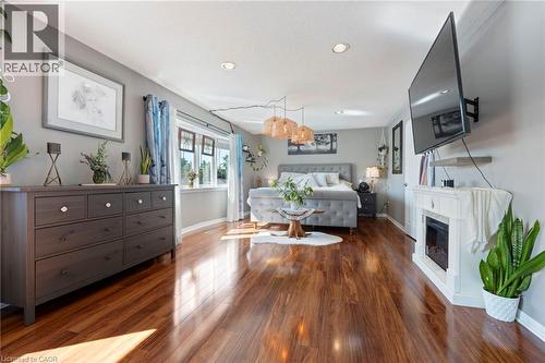 Wood-finish flooring, recessed lighting, multiple windows with natural light, and a built-in electric fireplace - 260 Granite Hill Road, Cambridge, ON 