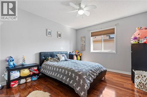 Wood-finish flooring, light gray wall paint, window with blinds, and a ceiling fan with integrated lighting - 260 Granite Hill Road, Cambridge, ON 