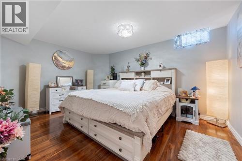 Wood-finish flooring, built-in shelving in headboard, overhead crystal lighting fixture, and a high-set window - 260 Granite Hill Road, Cambridge, ON 