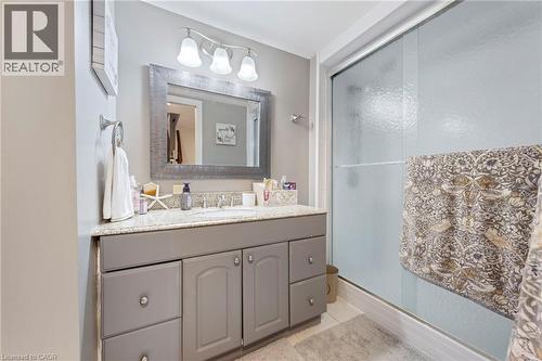 Bathroom featuring a vanity with a light-colored countertop, single basin sink, and ample cabinet storage - 260 Granite Hill Road, Cambridge, ON 