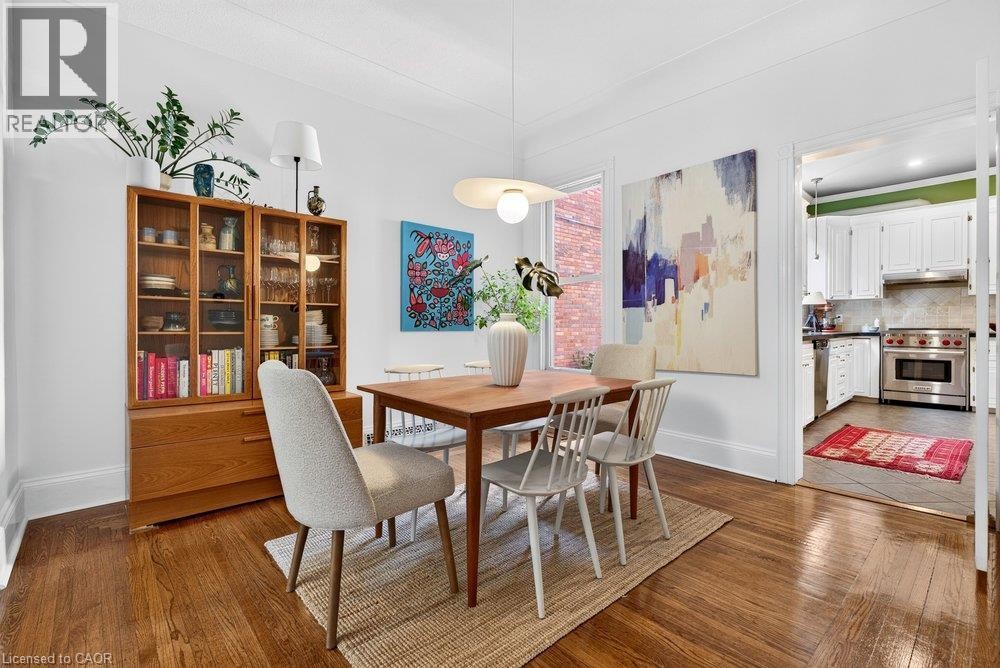 Hardwood flooring throughout, recessed lighting, white trim and baseboards, and a contemporary pendant light fixture - 16 Bruce Street, Hamilton, ON