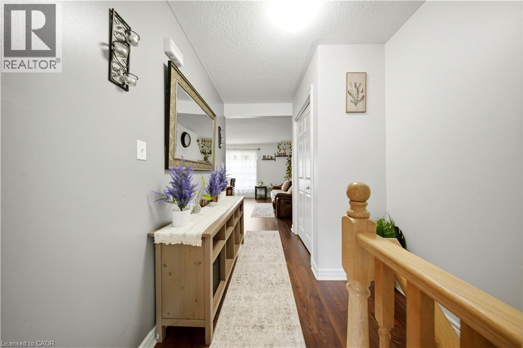 Wood-finish flooring, light grey wall paint, and white trim - 384 Limeridge Road E Unit# 16, Hamilton, ON