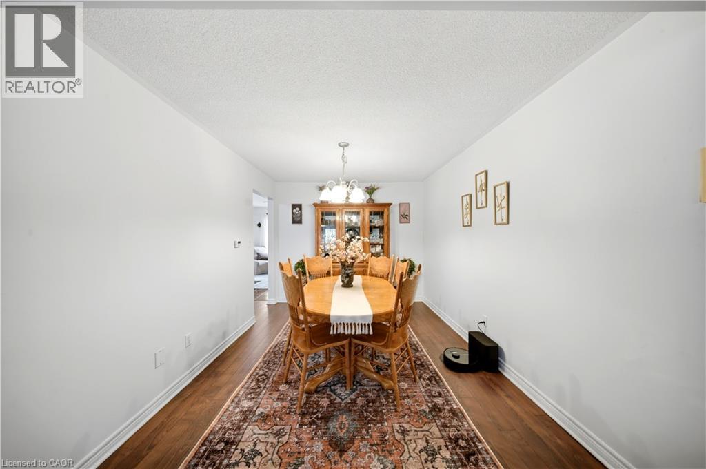 Hardwood-finish flooring, white painted walls, and a built-in display cabinet - 384 Limeridge Road E Unit# 16, Hamilton, ON
