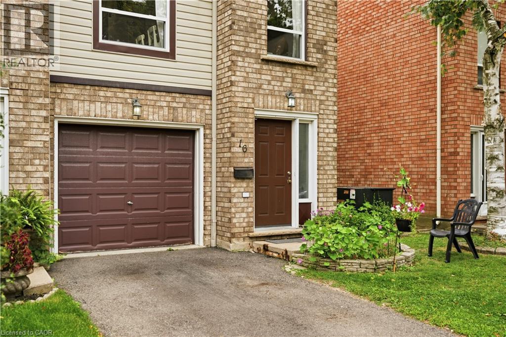 Brick and siding exterior with a brown panel garage door - 384 Limeridge Road E Unit# 16, Hamilton, ON