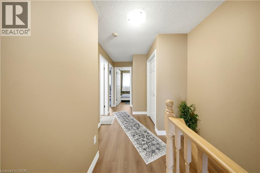 Hardwood-finish flooring, light-toned walls, and wood railings - 384 Limeridge Road E Unit# 16, Hamilton, ON