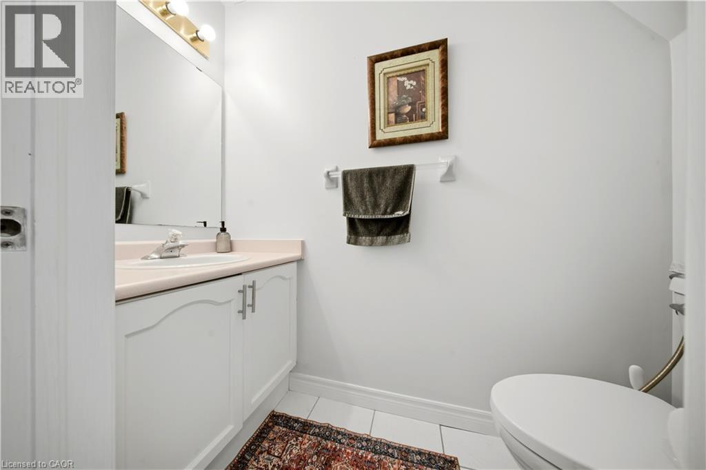 Vanity with a single basin, stainless steel faucet, under-cabinet storage, and white tile flooring - 384 Limeridge Road E Unit# 16, Hamilton, ON