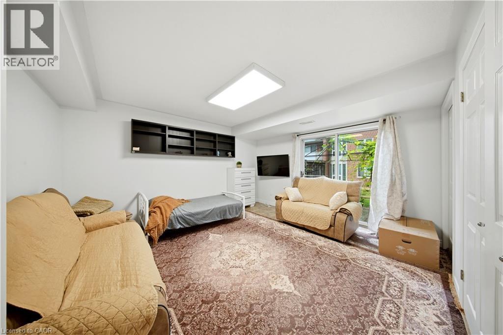 Recessed ceiling light fixture, built-in shelving, sliding glass door, and white paneled doors - 384 Limeridge Road E Unit# 16, Hamilton, ON