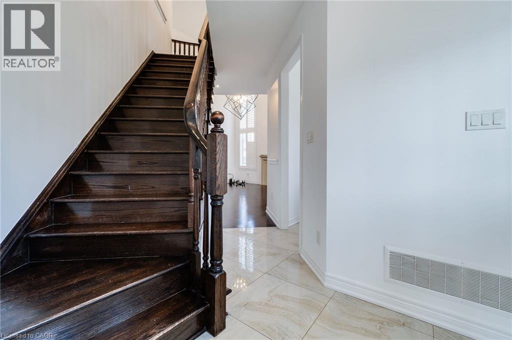 Dark wood staircase with turned newel post, balusters, and handrail - 2 Hawstone Road, Vellore, ON