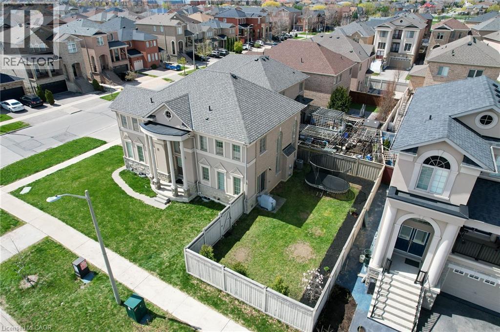 Two-story residential architecture with a prominent portico entrance, multiple windows, and a gray shingle roof - 2 Hawstone Road, Vellore, ON