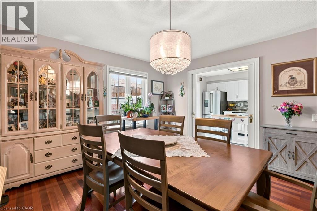 Wood-finish flooring, a decorative chandelier, and a built-in display cabinet - 31 Grindstone Way, Hamilton, ON