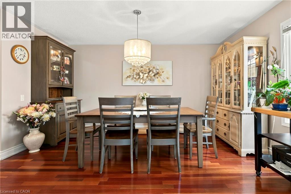 Hardwood flooring, elegant chandelier, painted walls, crown molding, double-hung window - 31 Grindstone Way, Hamilton, ON