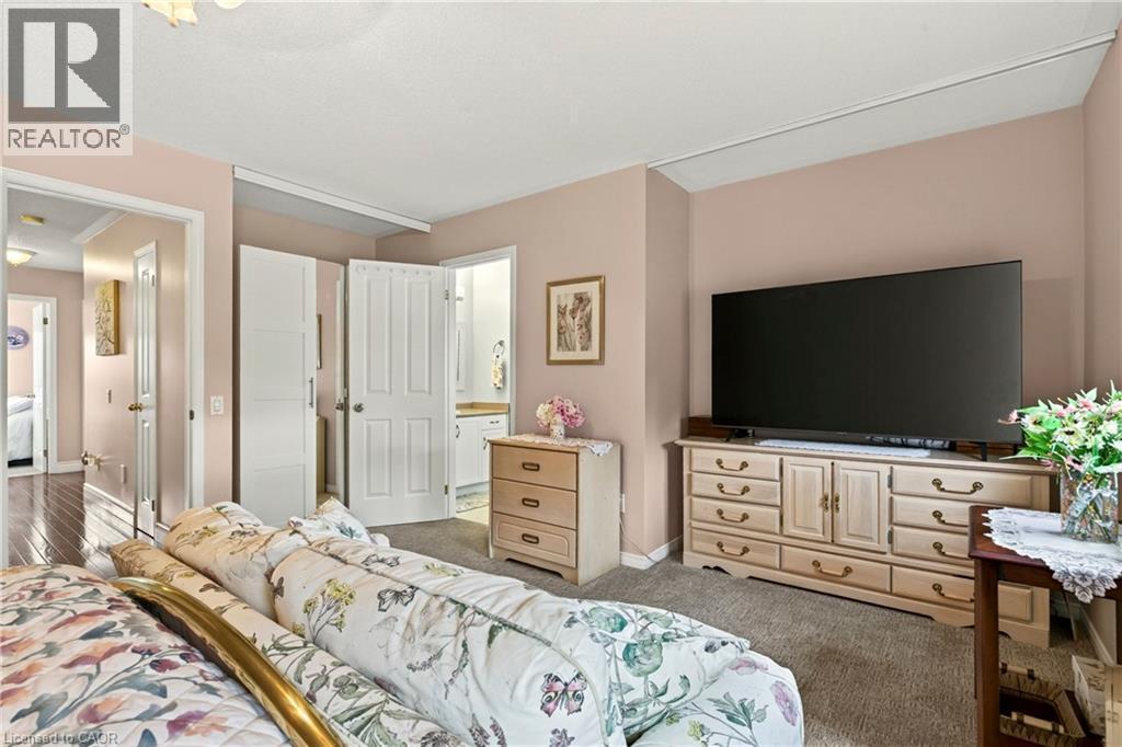 Carpeting throughout, light wall color, and a built-in closet with bi-fold doors - 31 Grindstone Way, Hamilton, ON