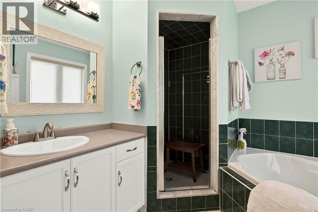 Vanity with an oval sink, brushed nickel faucet, and white cabinetry - 31 Grindstone Way, Hamilton, ON