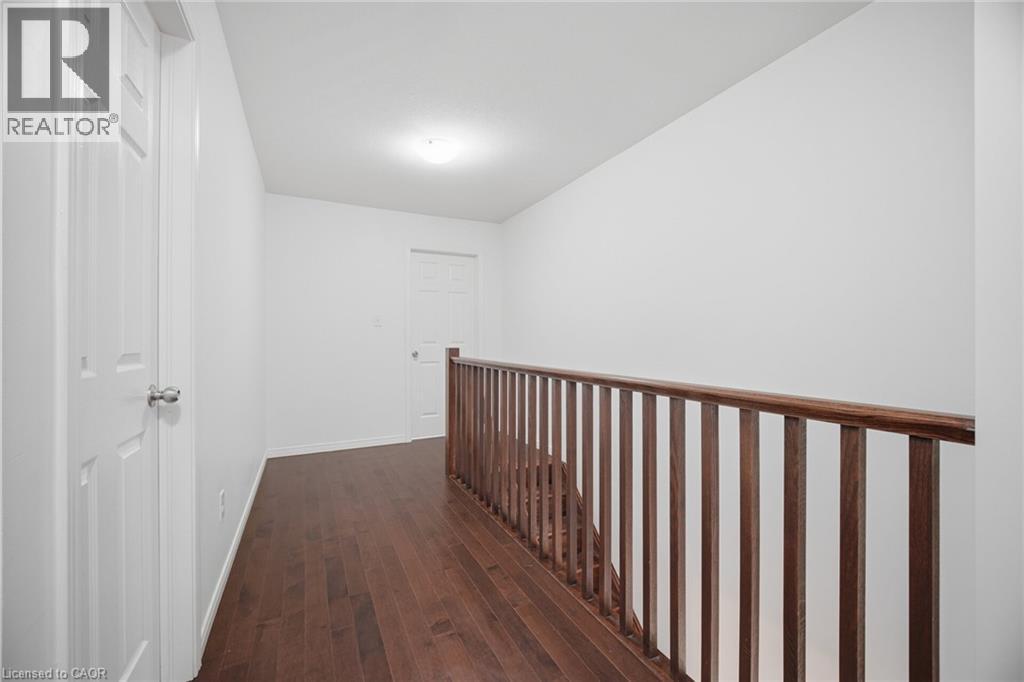 Hardwood flooring, painted walls, white paneled doors, and wooden railing - 135 Hardcastle Drive Unit# 85, Cambridge, ON
