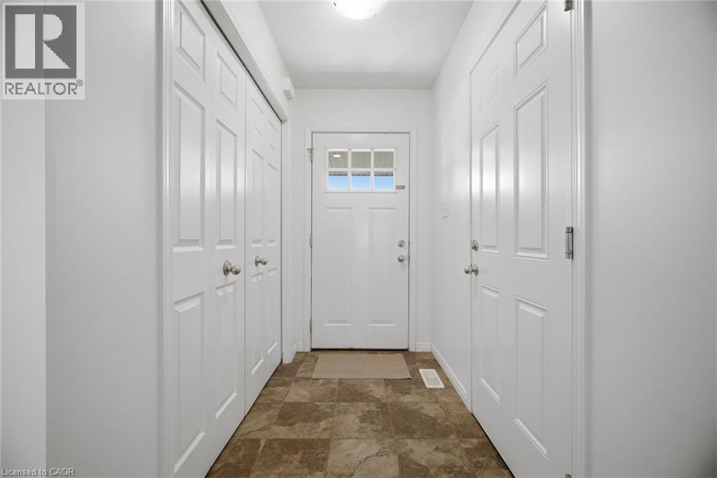 Tile flooring, white paneled doors, white walls, and a ceiling-mounted light fixture - 135 Hardcastle Drive Unit# 85, Cambridge, ON