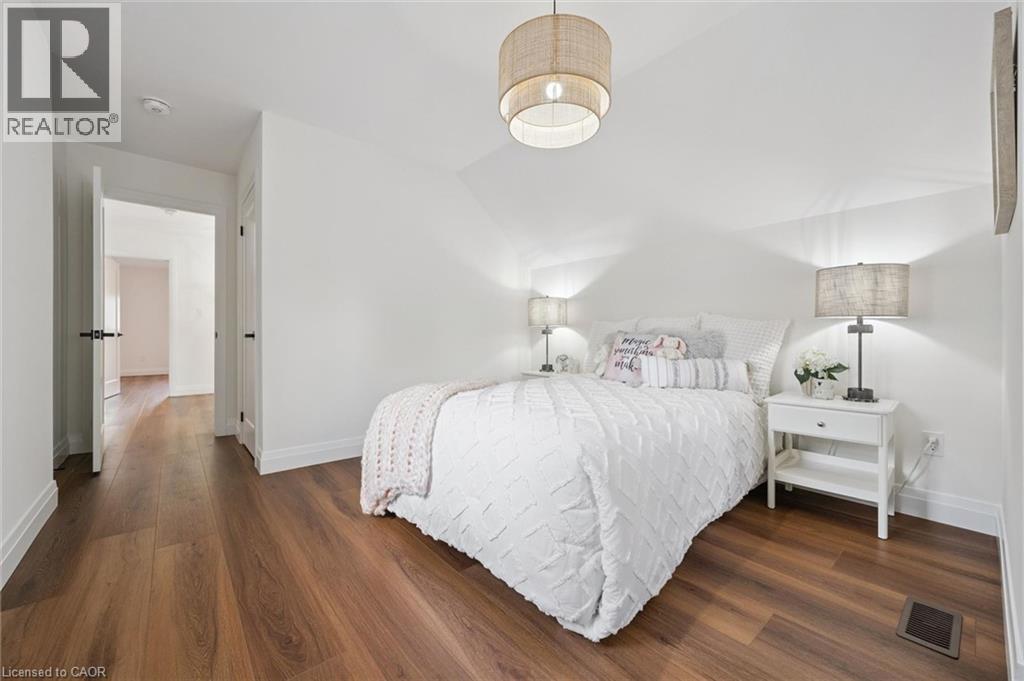 Warm wood-finish flooring complements the crisp white walls - 2294 Seton Crescent, Burlington, ON