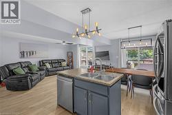 Open-concept living space with wood-finish flooring - 
