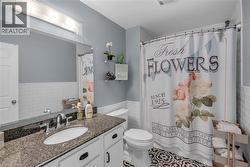 Vanity with a granite countertop, undermount sink, and chrome faucet - 