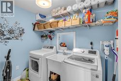 Laundry area featuring a utility sink with a chrome faucet, wall-mounted wire shelving, and a semi-flush mount ceiling light fixture - 