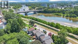 Riverfront properties featuring multiple bridges and dense surrounding tree coverage - 