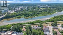 Aerial perspective showcasing a river, a bridge, and surrounding green spaces - 