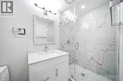 White vanity with a single basin sink, chrome faucet, and stone countertop - 