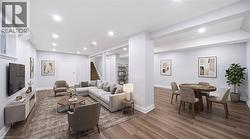 Expansive lower level with wood-finish flooring, recessed lighting, and white trim - 