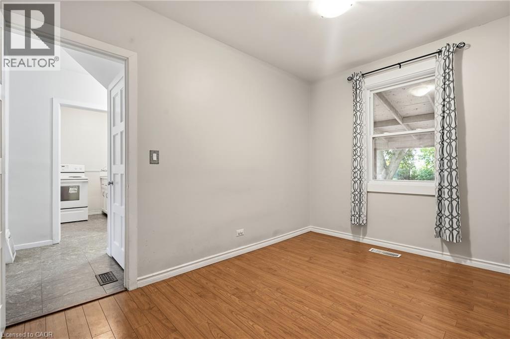 Wood-finish flooring and a white trim baseboard - 160 Lorne Crescent, Kitchener, ON