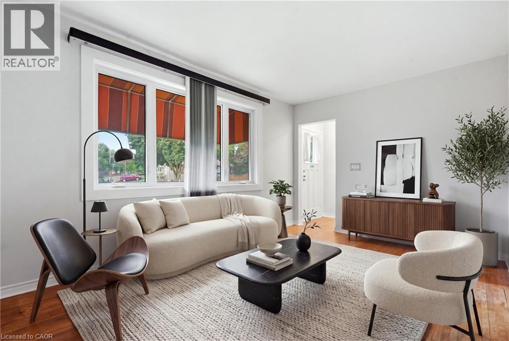 Hardwood flooring, white window trim, white walls, and a built-in wood-finish cabinet - 160 Lorne Crescent, Kitchener, ON