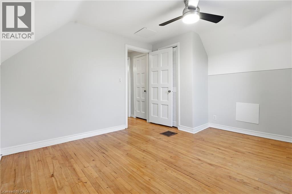 Hardwood flooring, painted walls, ceiling fan, and white paneled doors - 160 Lorne Crescent, Kitchener, ON