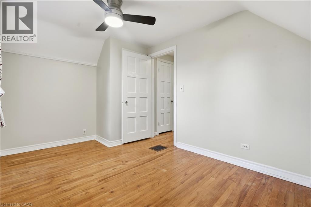 Hardwood flooring, painted walls, ceiling fan, white trim, and paneled interior doors - 160 Lorne Crescent, Kitchener, ON