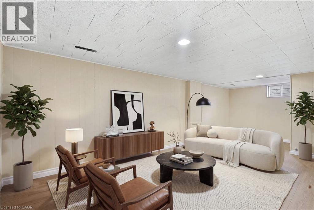 Wood-finish flooring, recessed lighting, drop ceiling, and light-toned wall paneling - 160 Lorne Crescent, Kitchener, ON