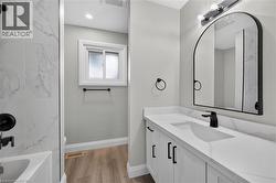 White vanity with black hardware, integrated sink, and white countertop - 