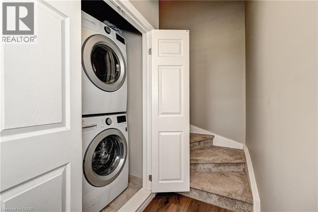 Stackable washer and dryer appliances, bi-fold closet doors, and carpeted stairs - 102 Wheat Lane, Kitchener, ON